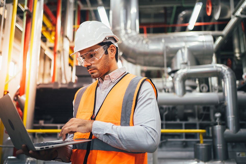 Professional,Worker,Of,Modern,Factory,Using,Laptop,Controlling,Program,To