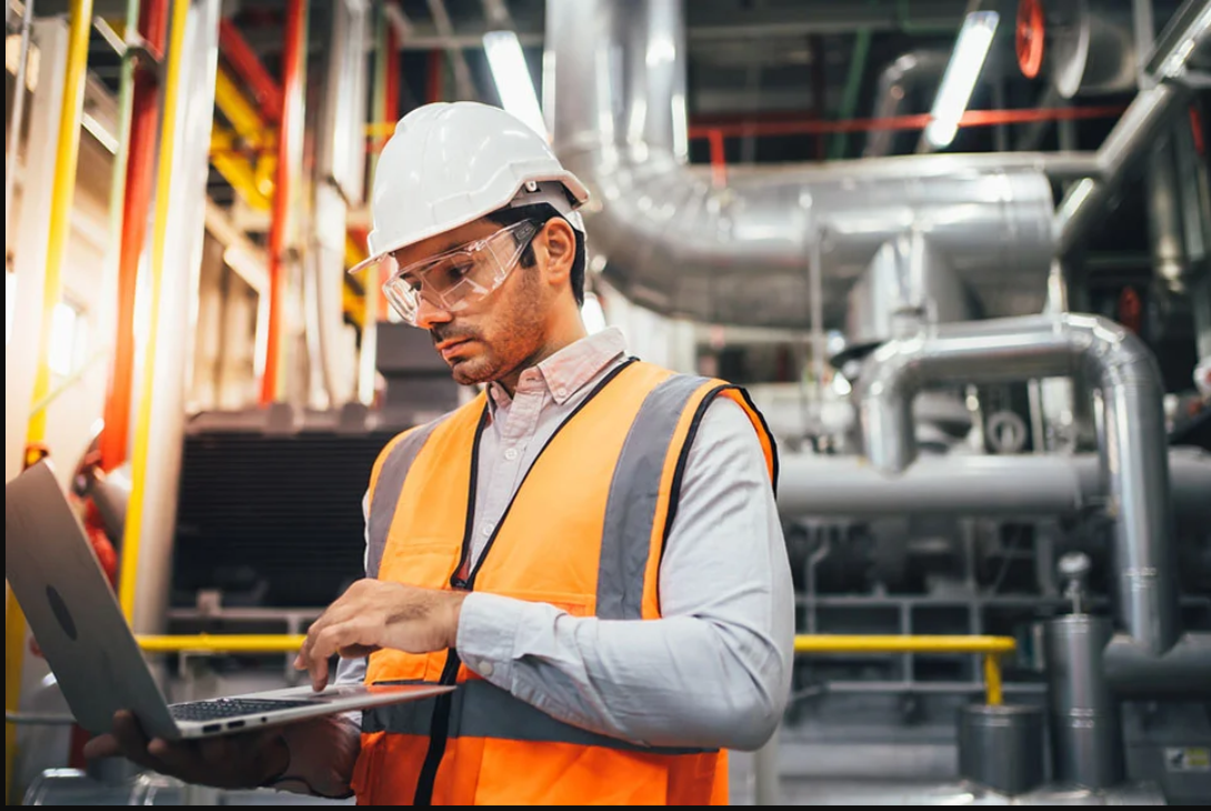 Professional worker controlling a programmable logic controller in a modern factory